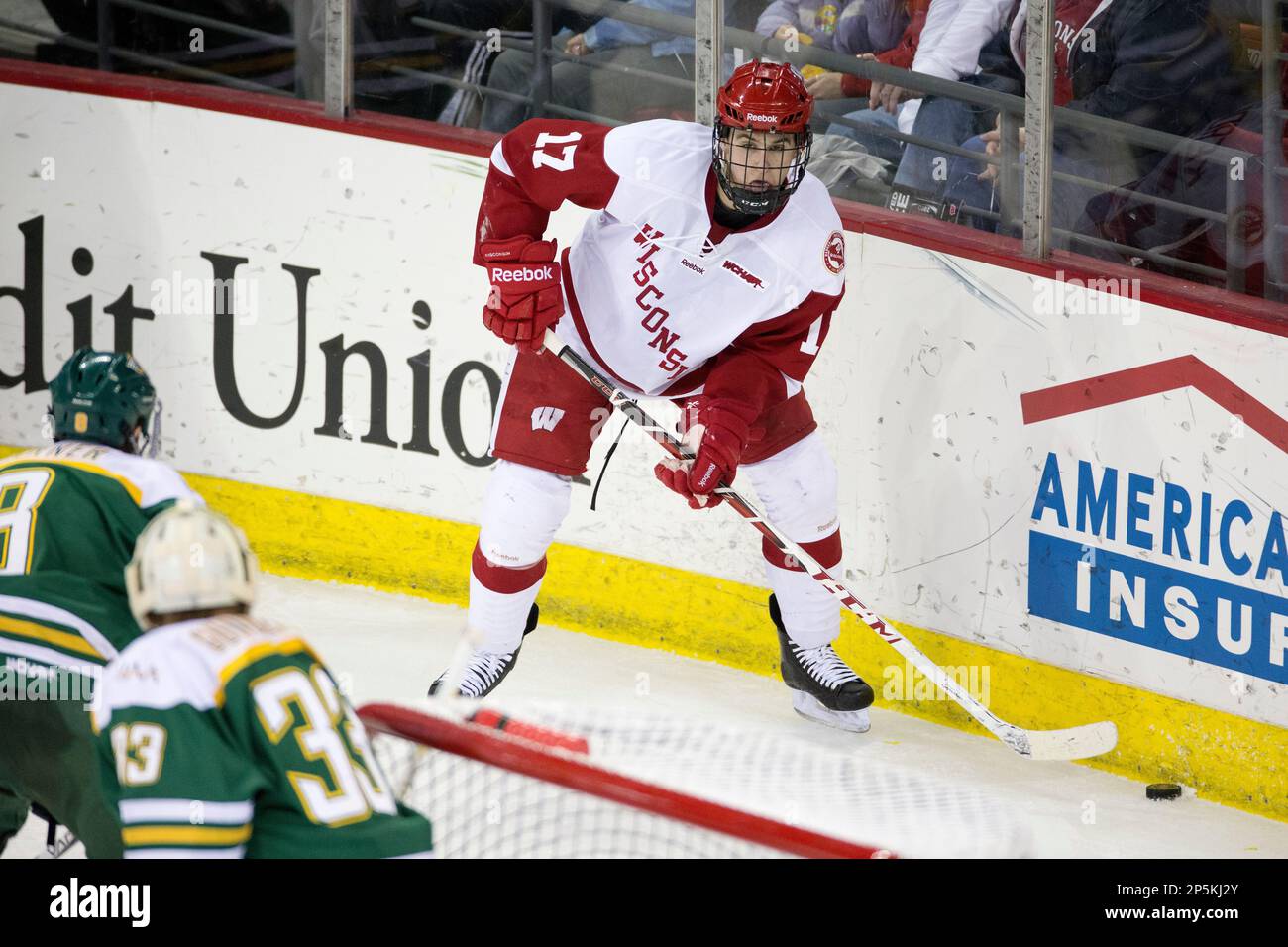Wisconsin Badgers Nic Kerdiles (17) handles the puck during an NCAA men