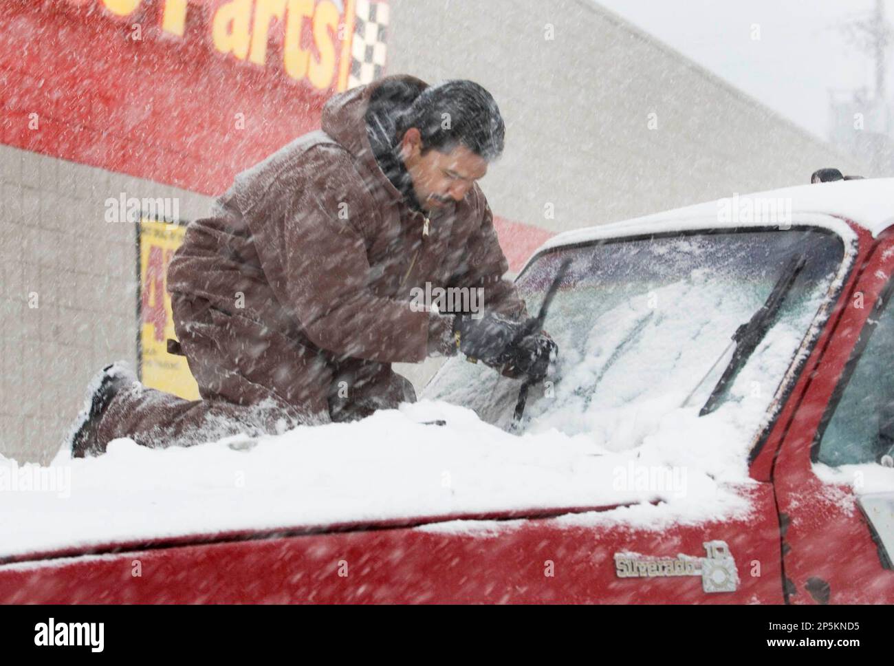 Abel Zurga, installs a new set of windshield wipers for his truck prior