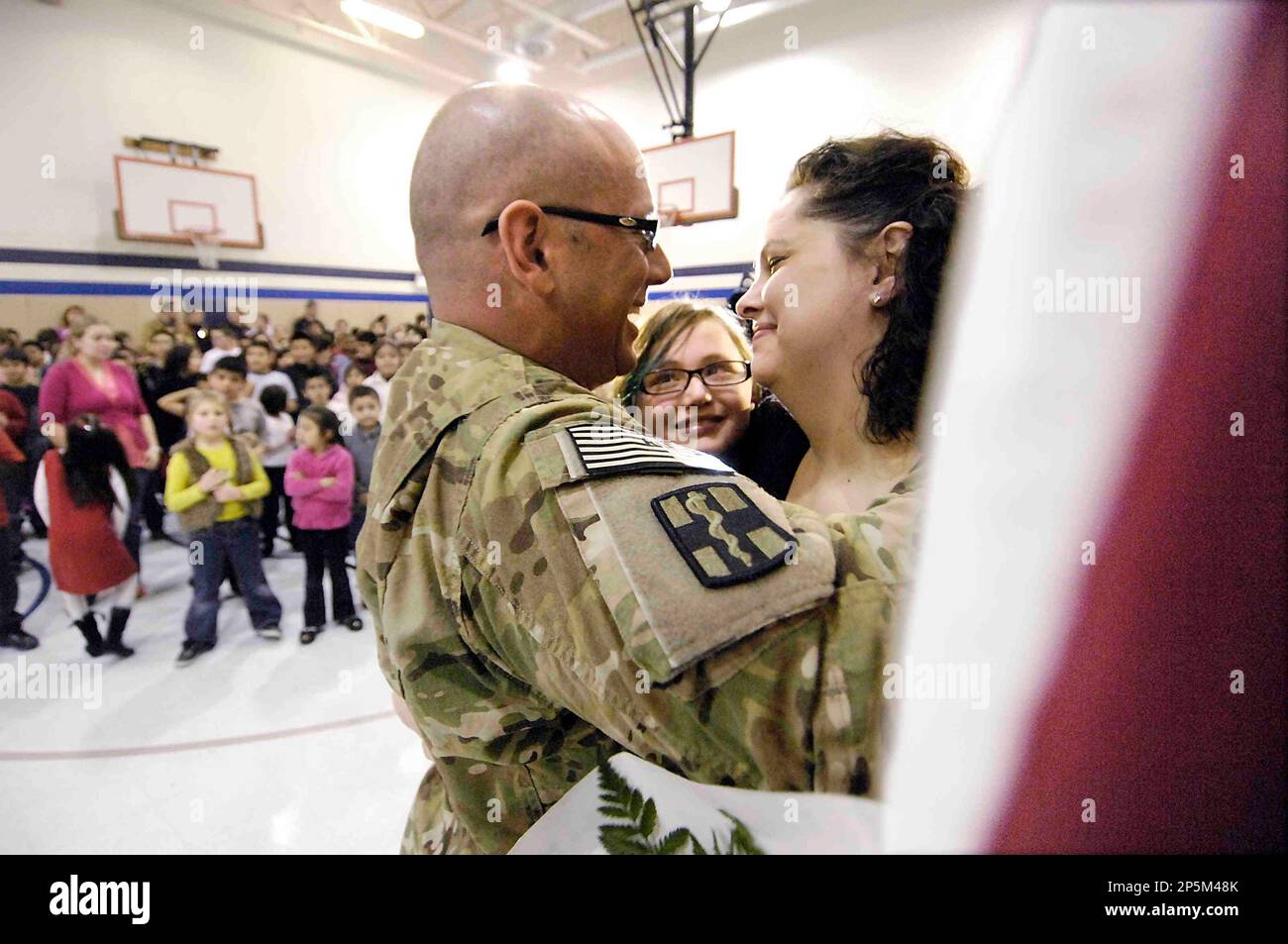 First Lt. Jordan Wolf hugs his daughter Kayla, a fifth grade student at