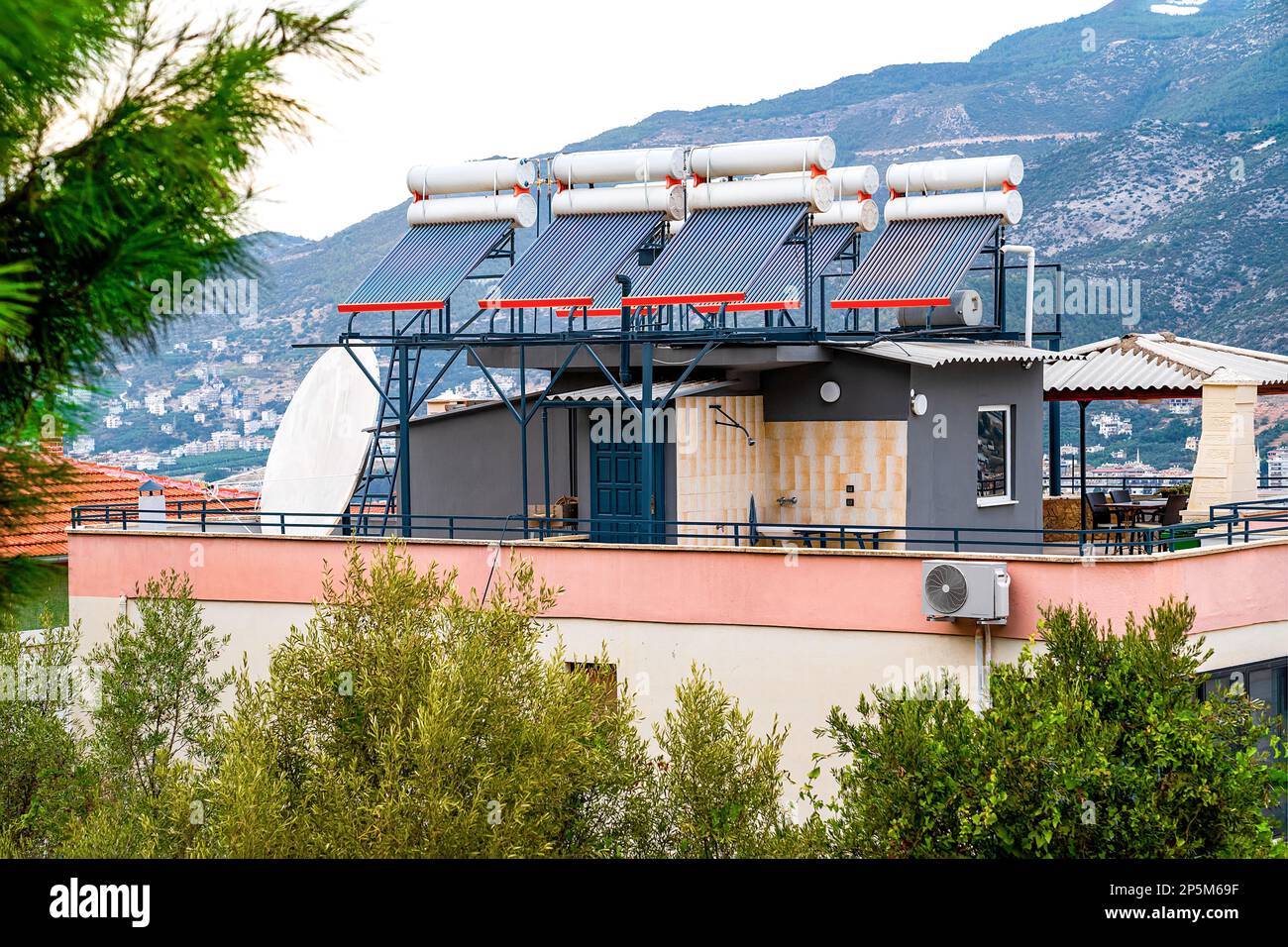 Solar panels heat water in barrels installed on roof of residential ...