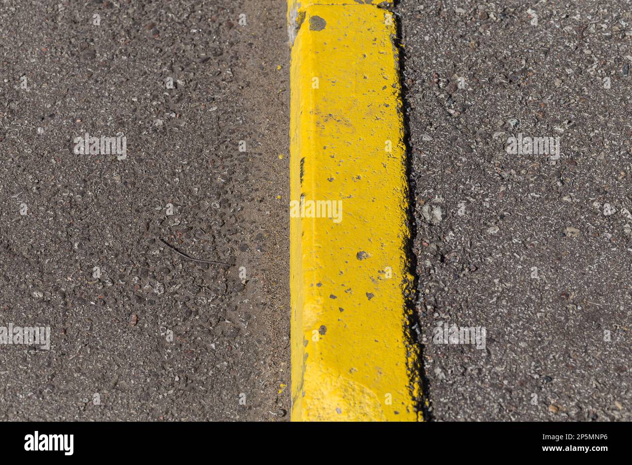 Yellow curb stone border and asphalt road Stock Photo Alamy