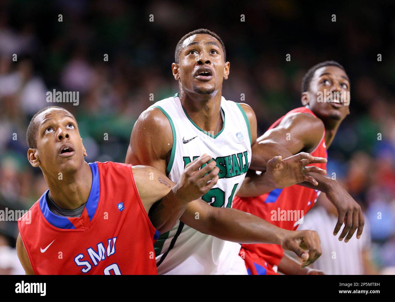 Marshall's Elijah Pittman, center, looks for a rebound against SMU's Jordan  Dickerson, left, and Ryan Manuel during an NCAA college basketball game  Wednesday, Jan. 30, 2013, at the Cam Henderson Center in