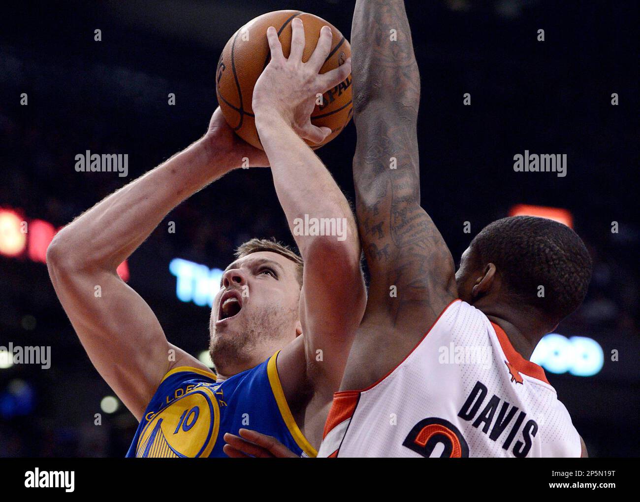 Golden State Warriors David Lee jumps past Toronto Raptors Ed Davis ...