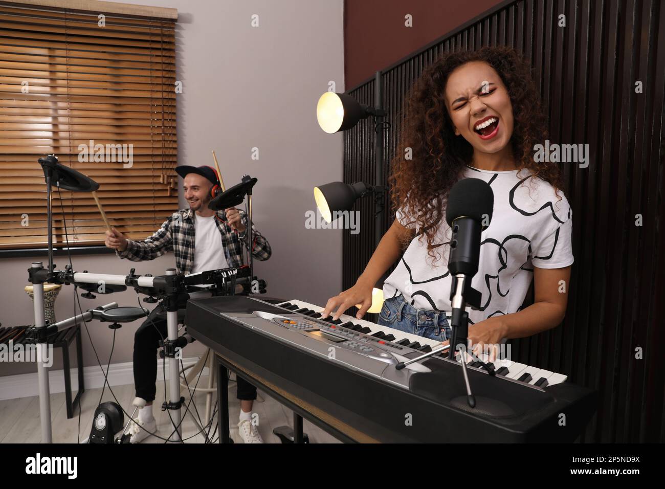 Music band performing in modern recording studio Stock Photo - Alamy