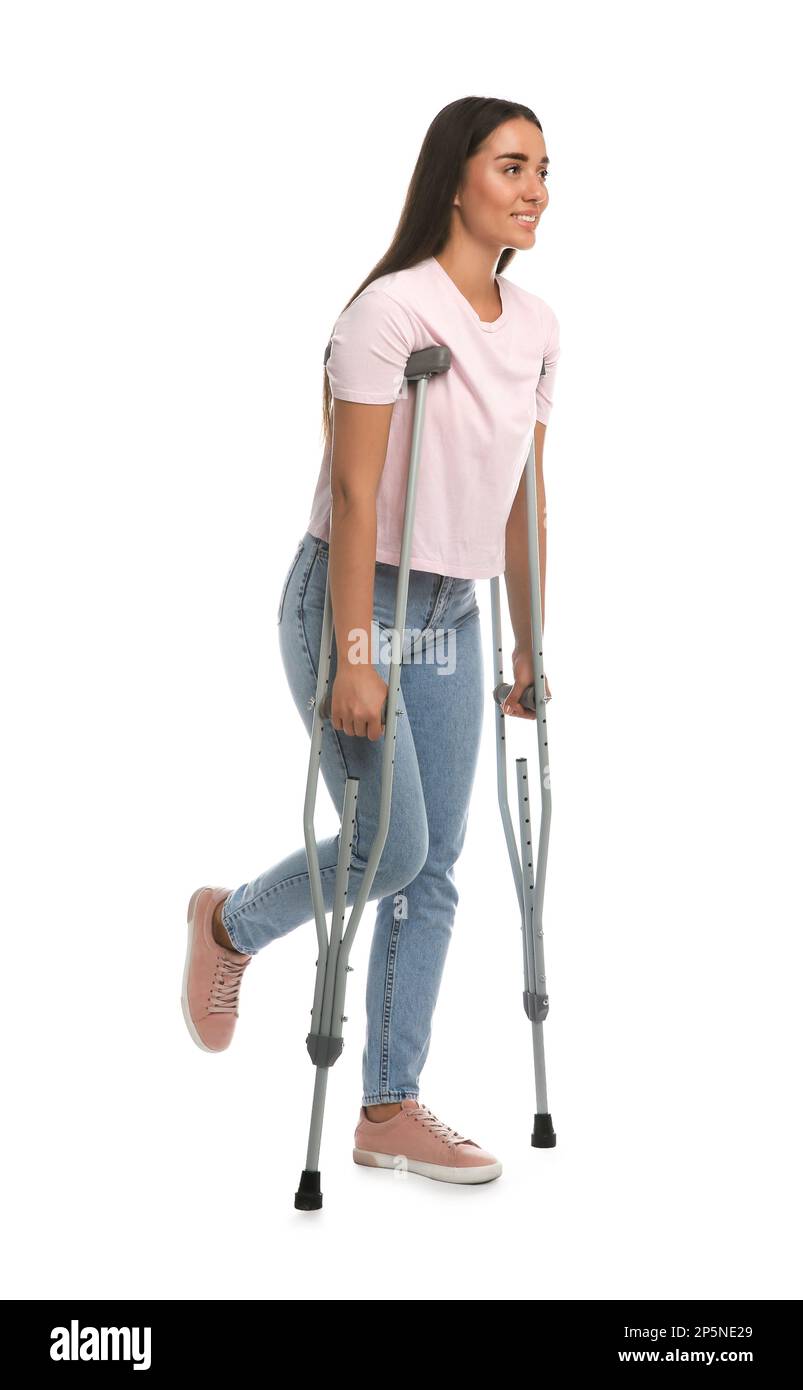 Young woman with axillary crutches on white background Stock Photo Alamy