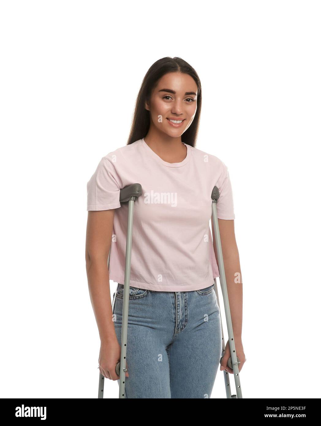 Young woman with axillary crutches on white background Stock Photo Alamy