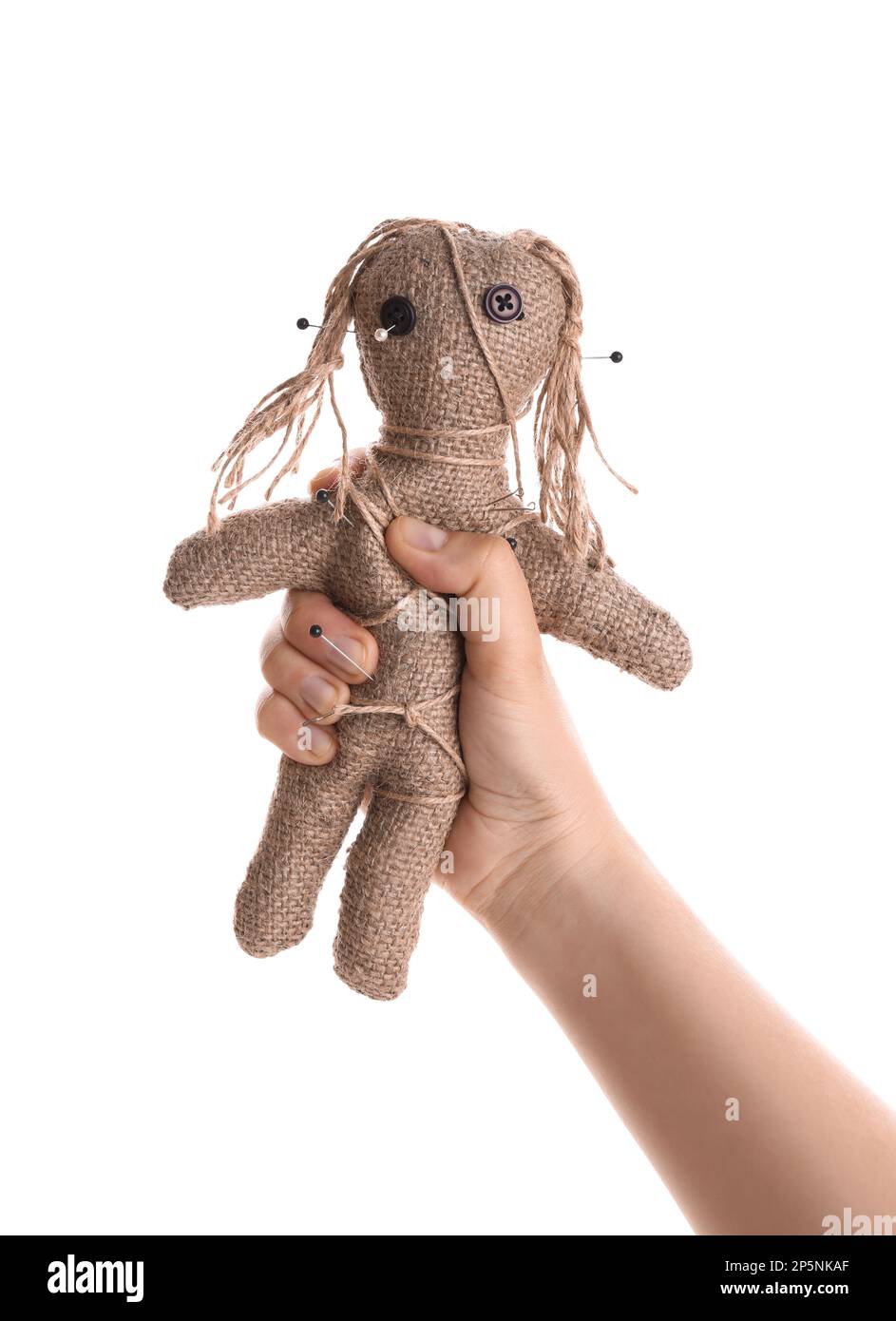 Woman holding voodoo doll with pins on white background, closeup. Curse ceremony Stock Photo