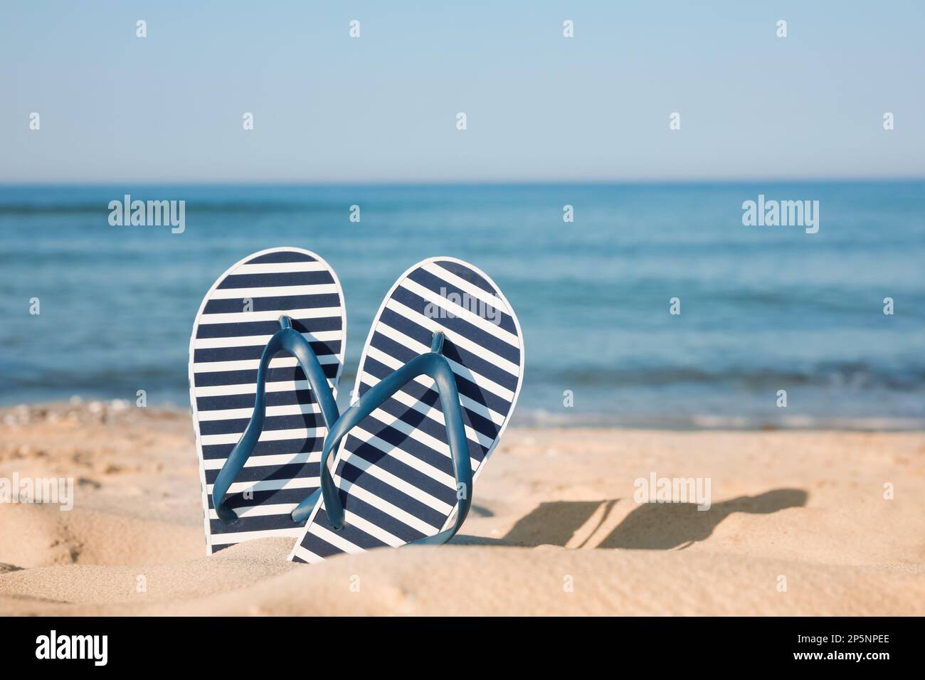 Stylish Striped Bag Slippers Seashell Sandy Beach Sea Stock Photo by  ©NewAfrica 616479018