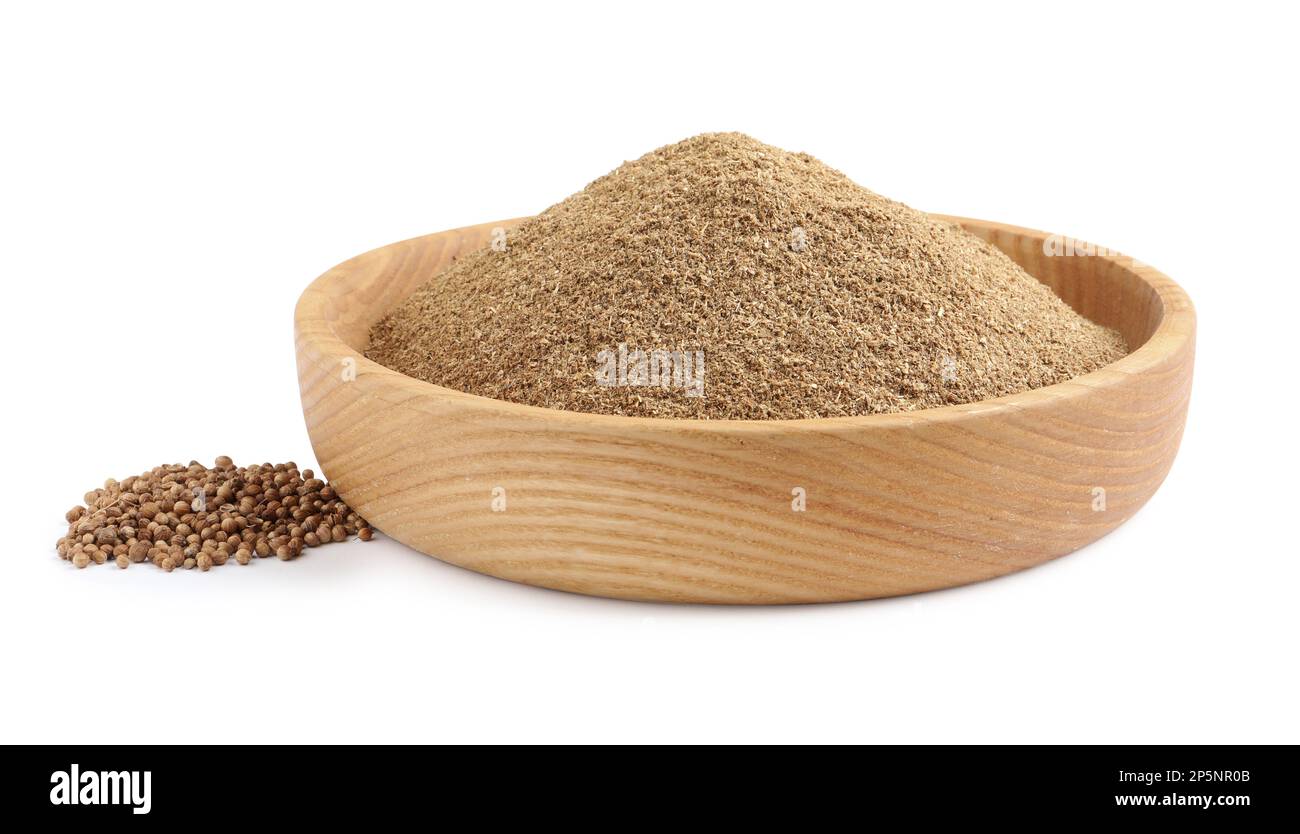 Wooden bowl with powdered coriander and corns on white background Stock ...