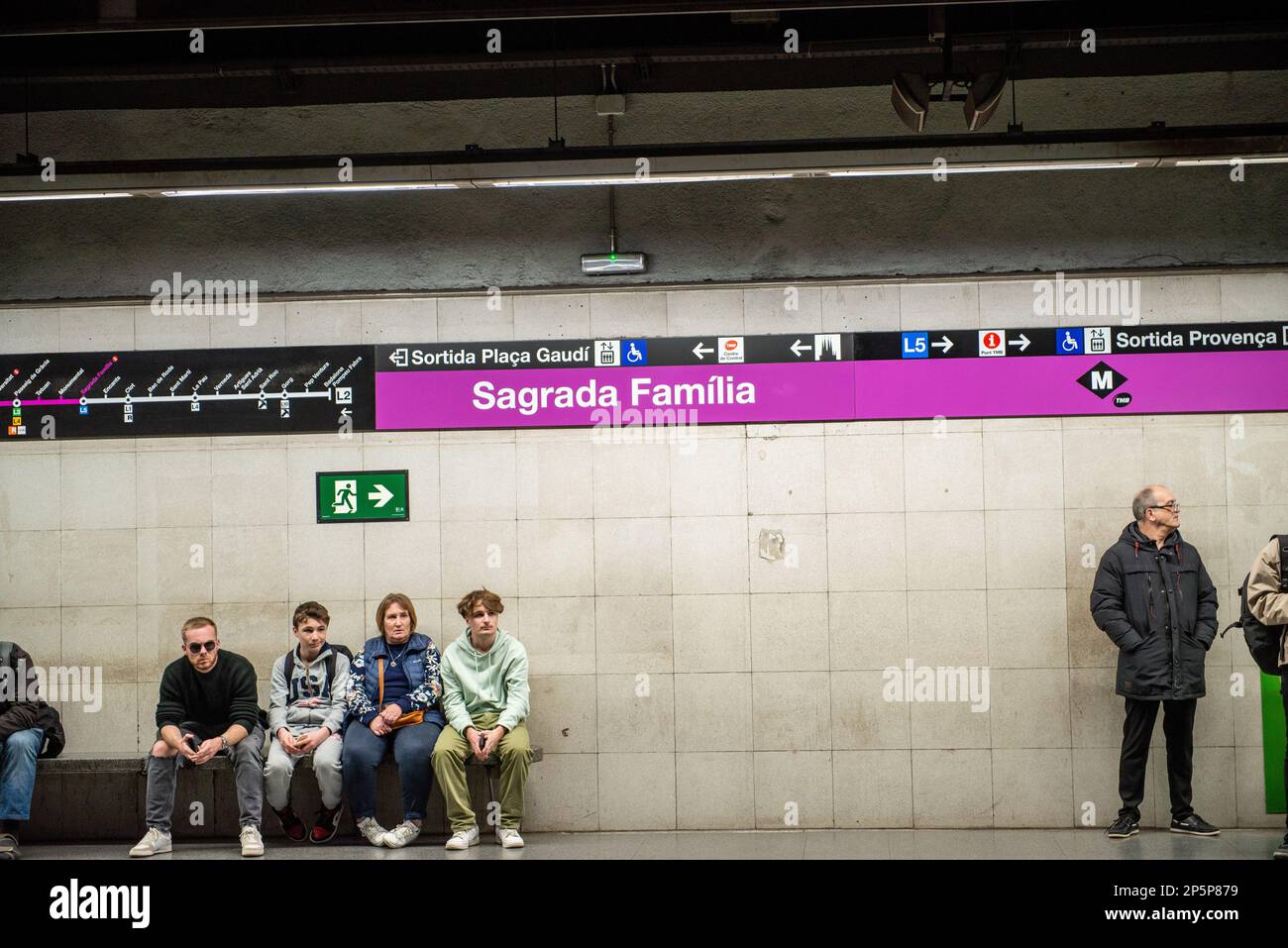 Barcelona,Spain-February 22,2023:Passengers wait for a subway train at a station under  the Sagrada Familia church. Stock Photo