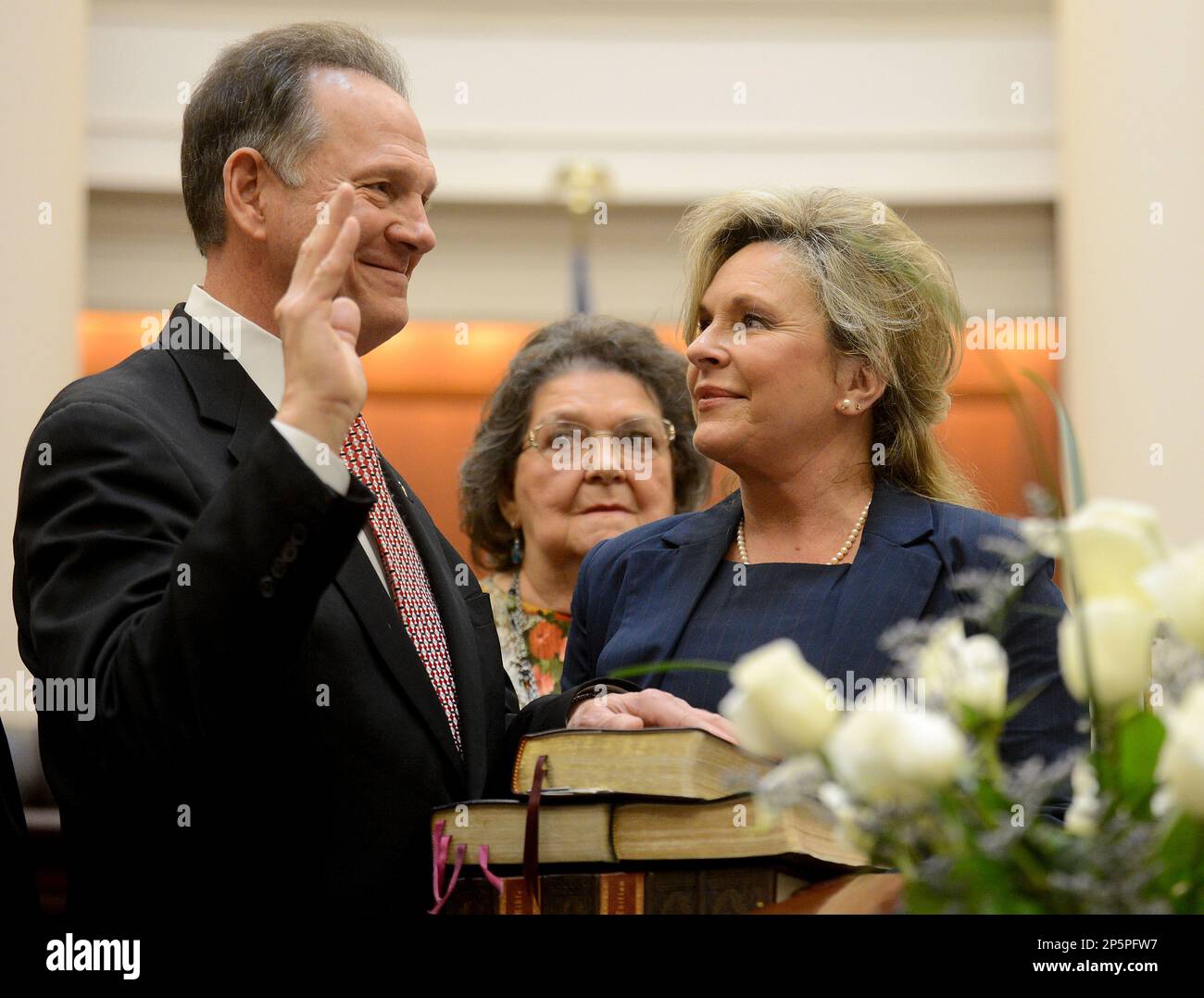 Alabama Chief Justice Roy Moore takes the oath of office Friday, Jan. 11, 2013, as his wife