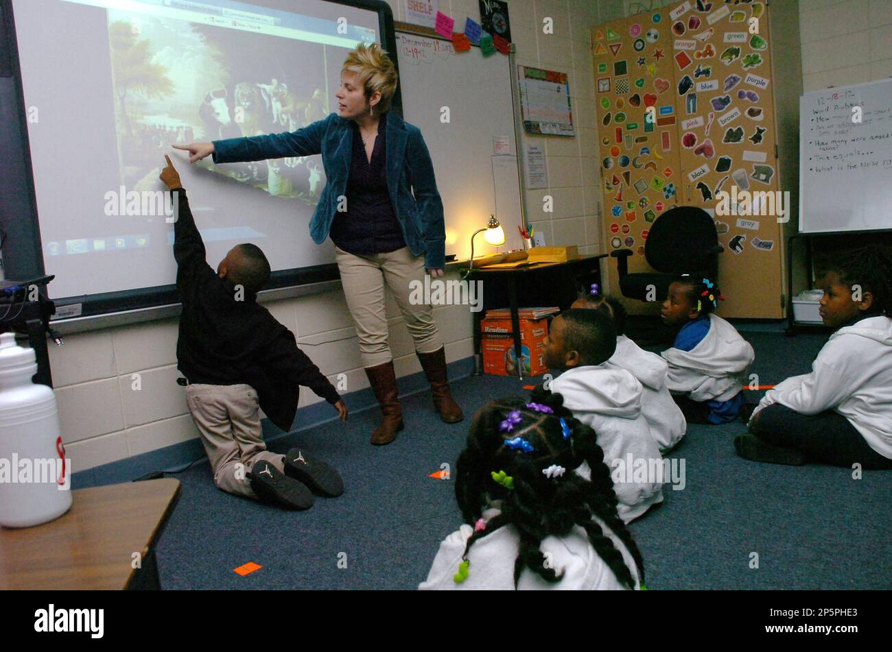 Julius Patrick Elementary School pupil Terry Lotts, front left, points out a duck to Alexandria Museum of Art resident artist Cindy Blair Wednesday, Dec. 19, 2012, in Alexandria, La. The Alexandria Museum of Art is working with local elementary schools to provide Visual Thinking Strategies (VTS) training and implementation. (AP Photo/The Daily Town Talk, Melinda Martinez) NO SALES Stock Photo