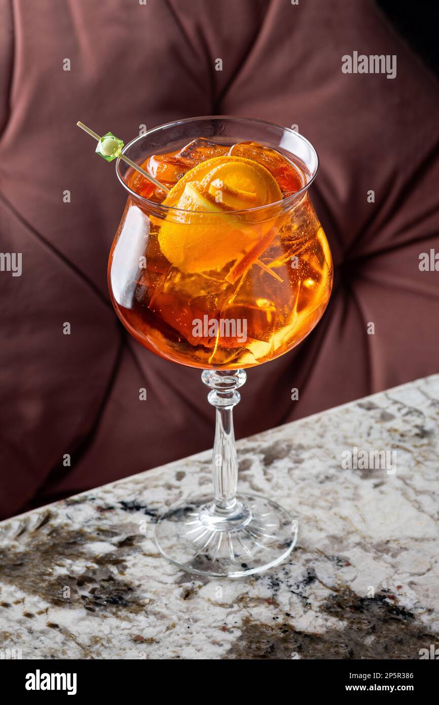 Aperol is an alcoholic cocktail. Orange. Cold drink with ice cubes. The ...