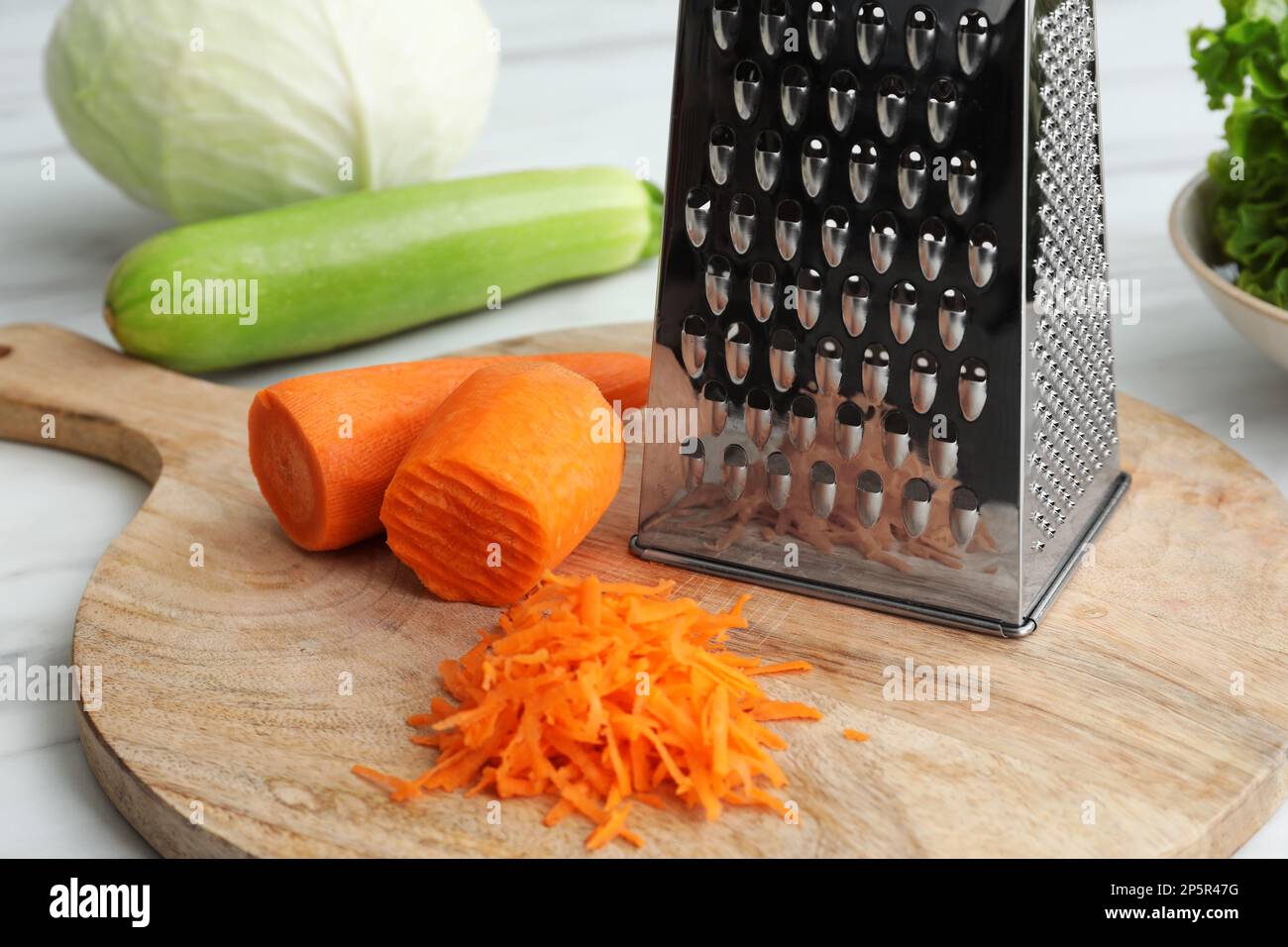 Grater with carrot domestic shredder Royalty Free Vector