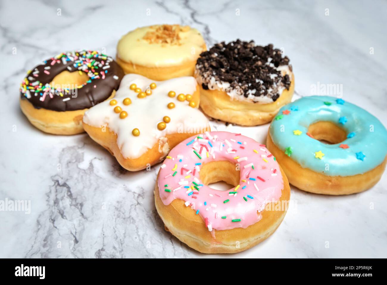 several different donuts on a white background Stock Photo - Alamy