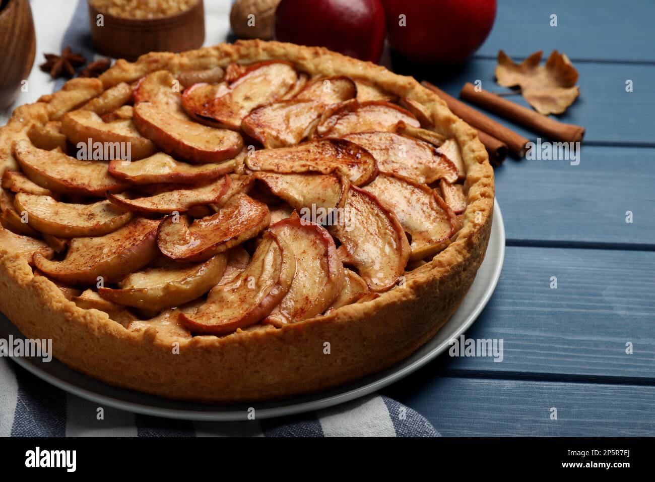 Delicious apple pie on blue wooden table, closeup Stock Photo
