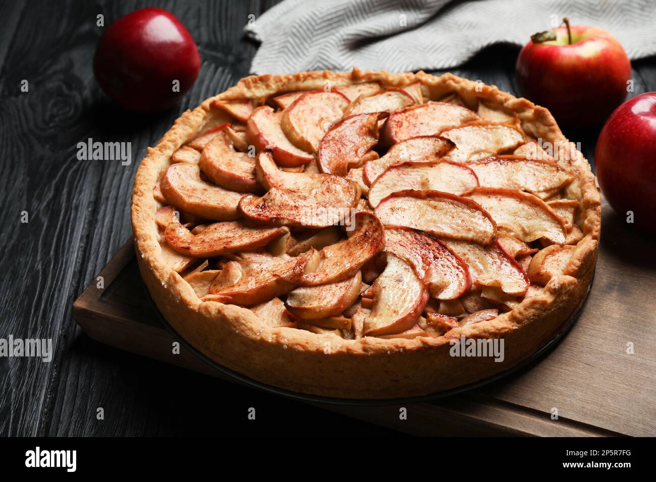 Delicious apple pie and fresh fruits on black wooden table Stock Photo