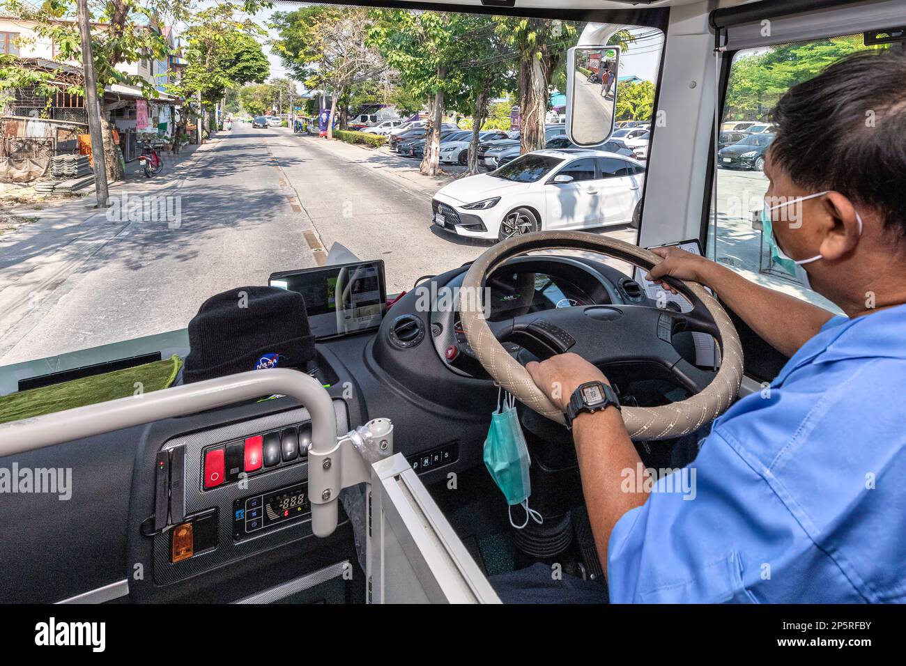 Thai driver of electric shuttle bus traveling around Bangkok floating markets on weekends, Thailand Stock Photo