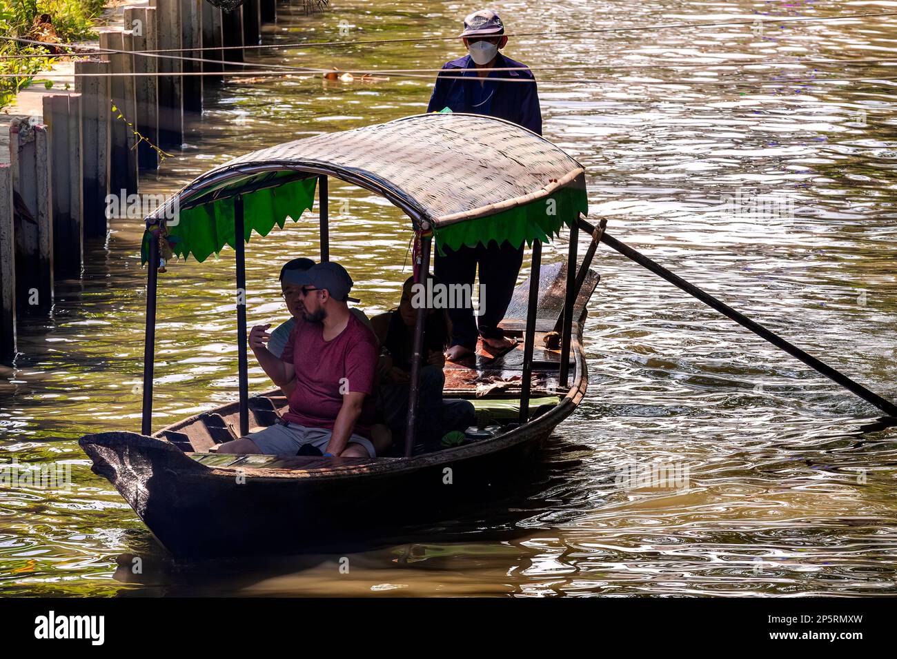 Longtail and tourist boats on khlong at Lad Mayom Floating Market, Bangkok, Thailand Stock Photo