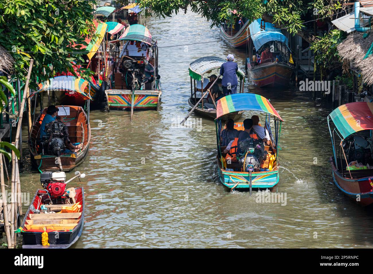 Longtail and tourist boats on khlong at Lad Mayom Floating Market, Bangkok, Thailand Stock Photo
