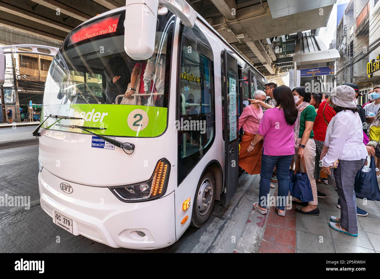 Passengers boarding electric shuttle bus at terminus, Bangkok, Thailand Stock Photo