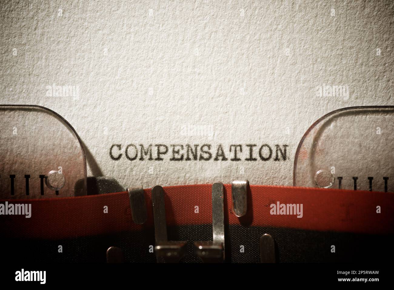 Compensation word written with a typewriter Stock Photo Alamy