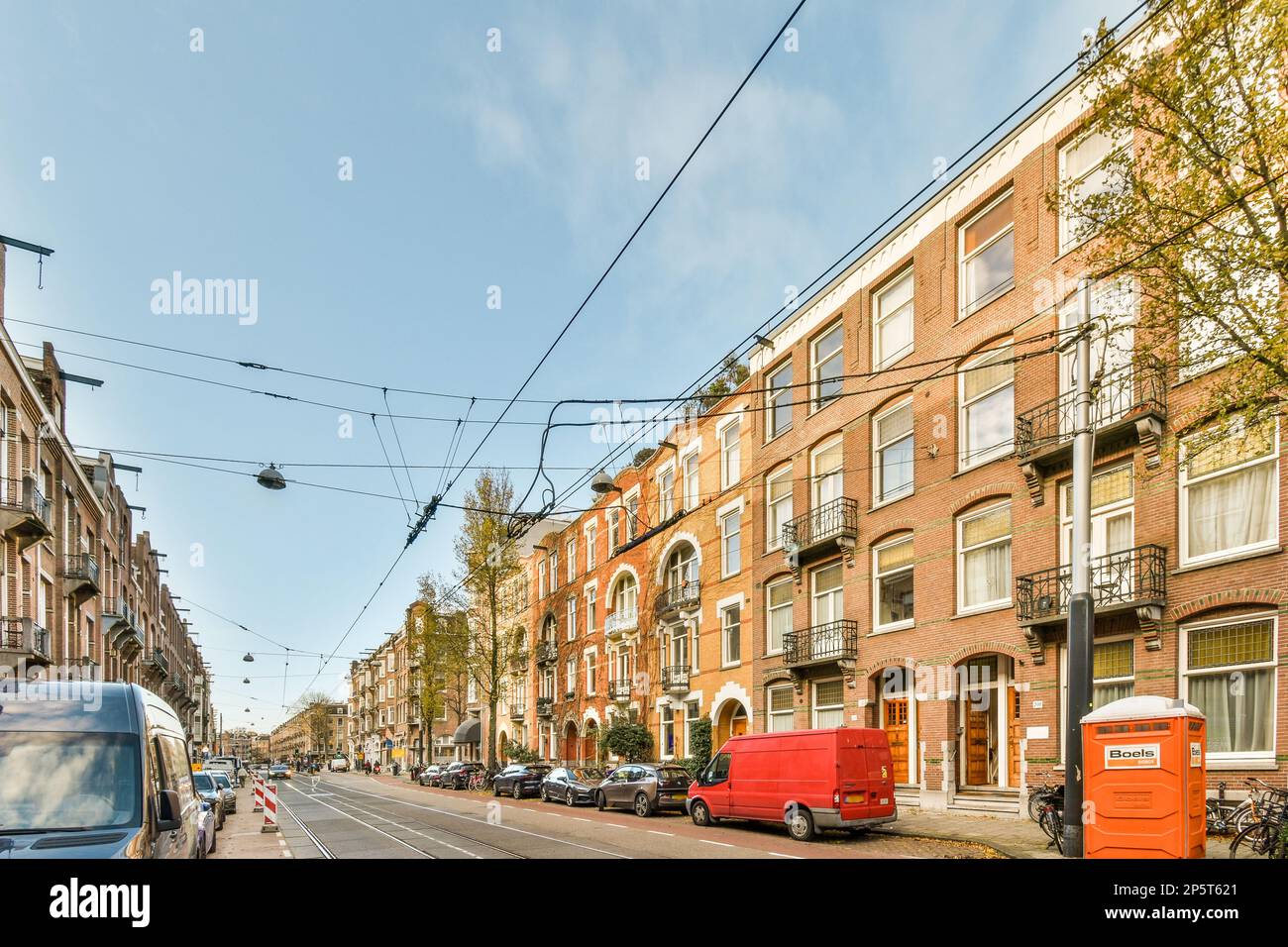a city street with cars parked on the side and buildings in the ...