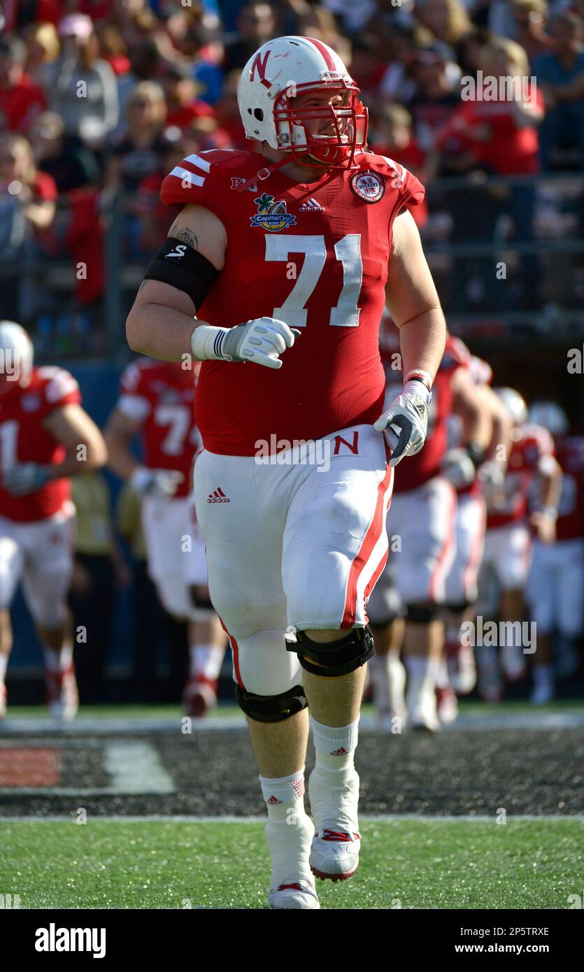 Nebraska offensive lineman Jeremiah Sirles (71) runs onto the field for