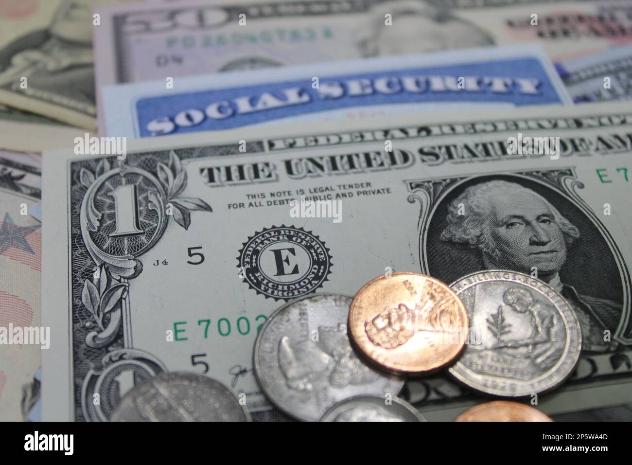 US dollars and coins with Social Security card Stock Photo