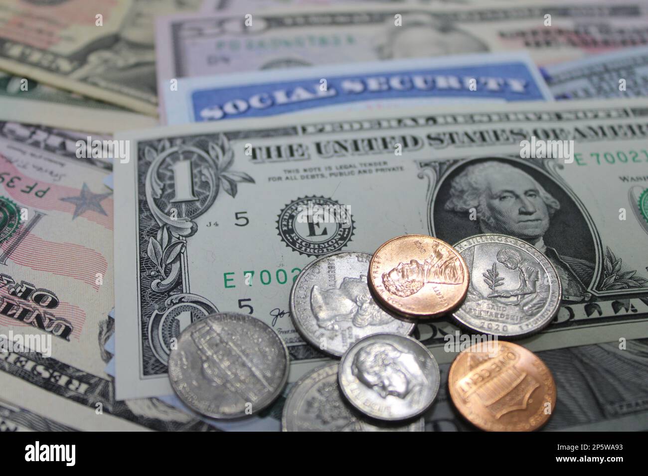 US dollars and coins with Social Security card Stock Photo