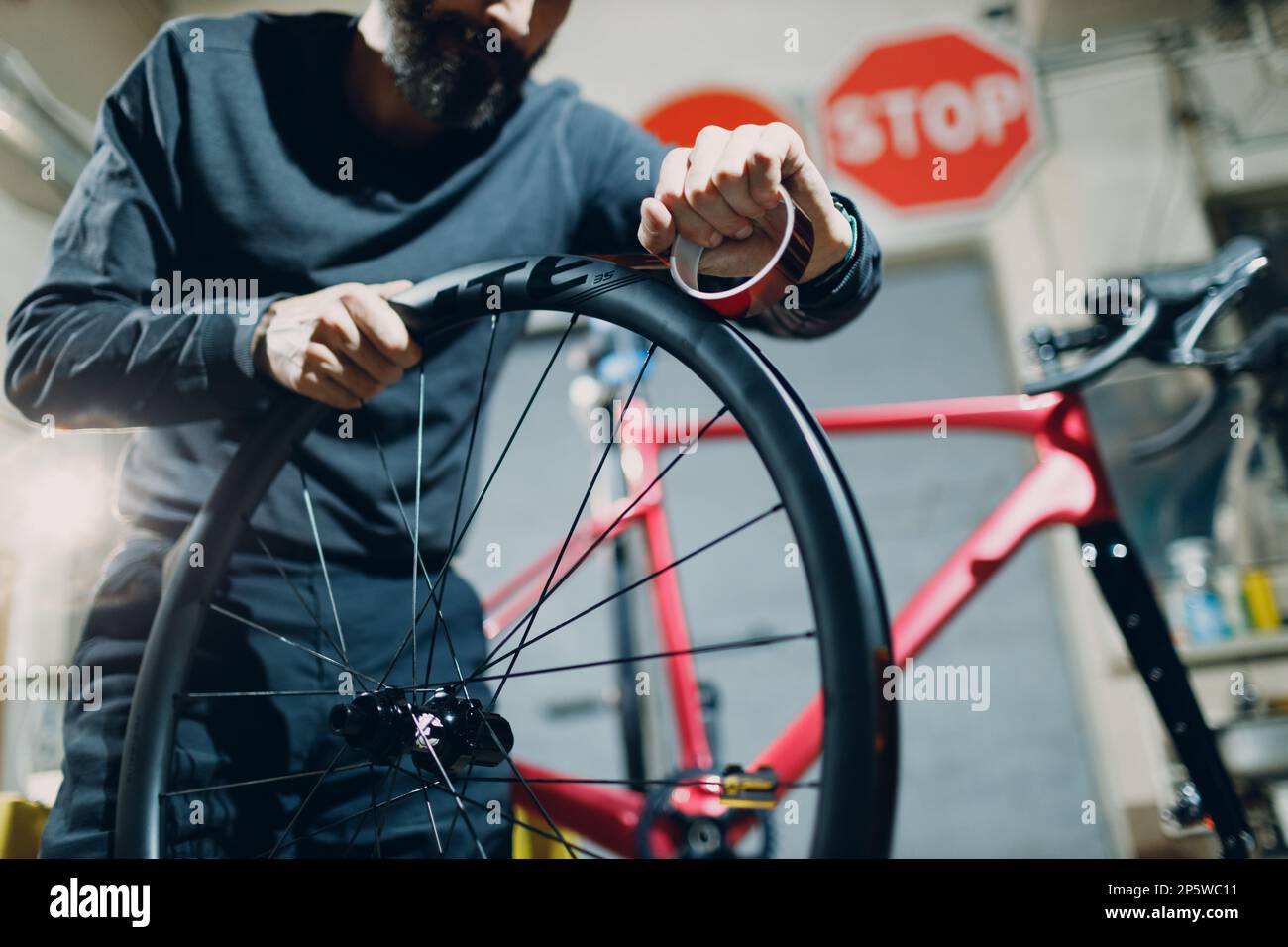 Mechanic repairman assembling wheel install tape sealant for bike tire