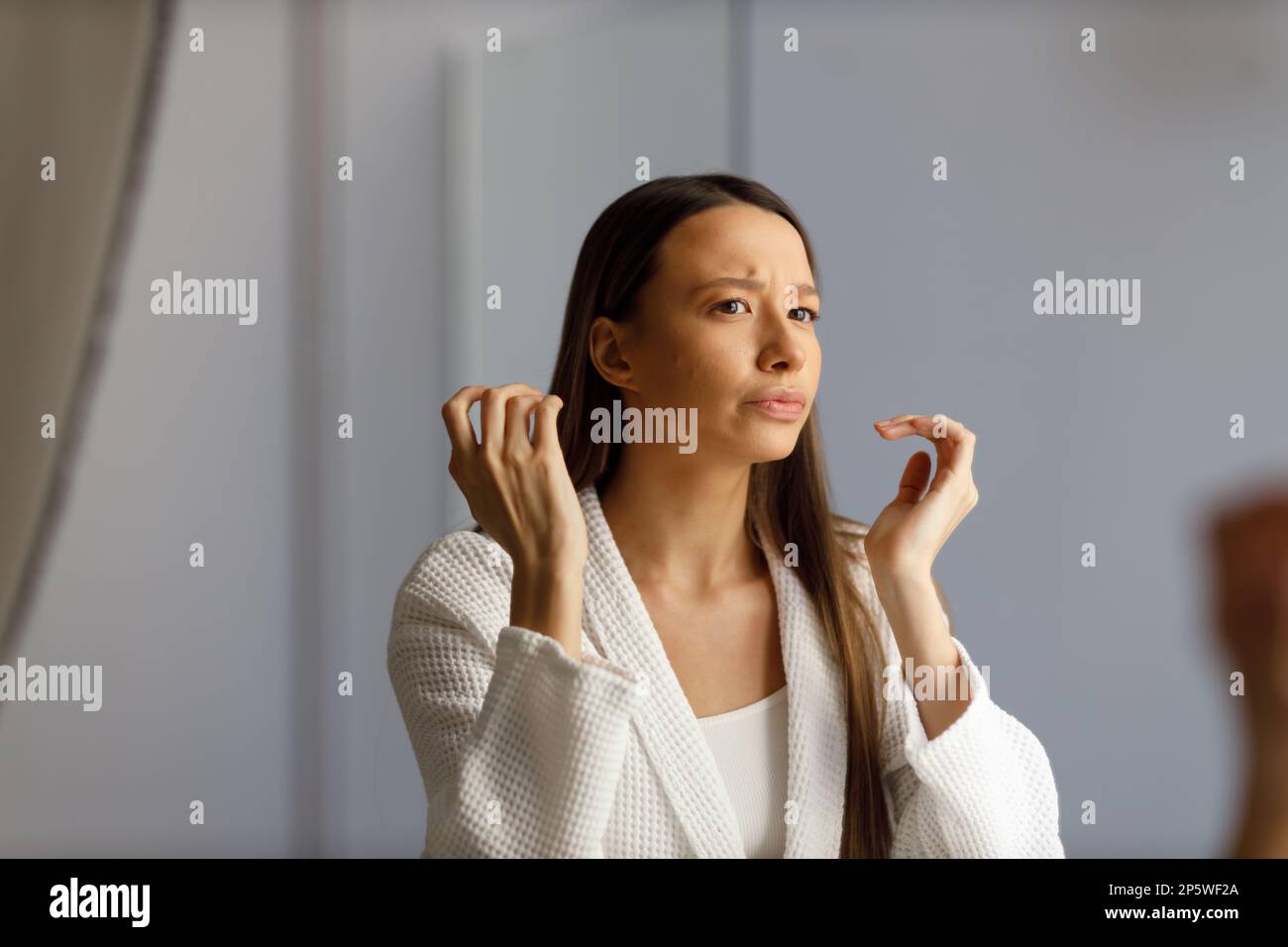Attractive Upset Young Woman In White Bathrobe Examines Pimples On Her Face Problematic Skin On 7195