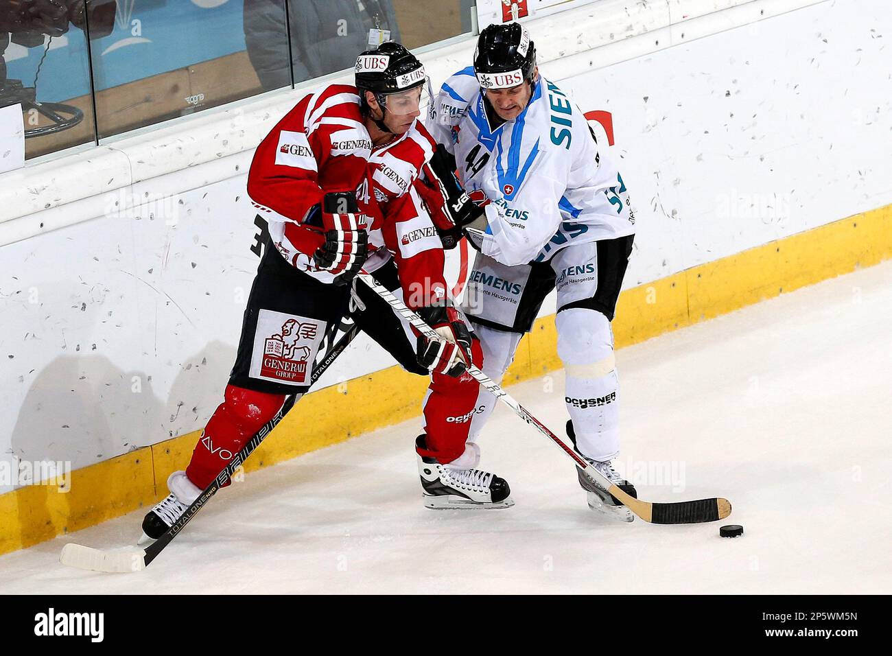 Team Canada's Ryan Smyth, left, vies for the puck with Fribourg's Shawn  Heins, right, during the semi-final match between Team Canada and HC  Fribourg Gotteron at the 86th Spengler Cup ice hockey tournament, in Davos,  Switzerland, Sunday, Dec. 30