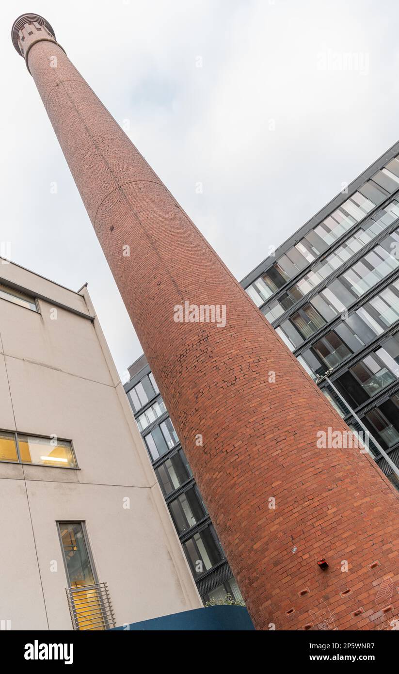 Quirky angle view of the old Dublin Gasworks Chimney in the redevelopment of Grand Canal Dock, Dublin, Ireland Stock Photo