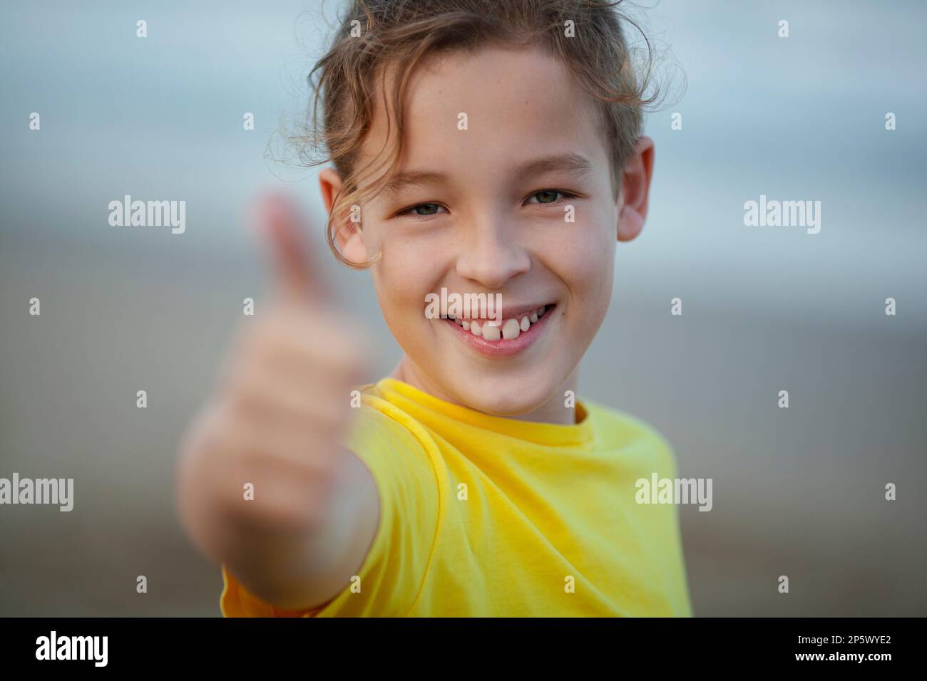 Outdoor portrait of a happy boy with thumbs-up Stock Photo - Alamy