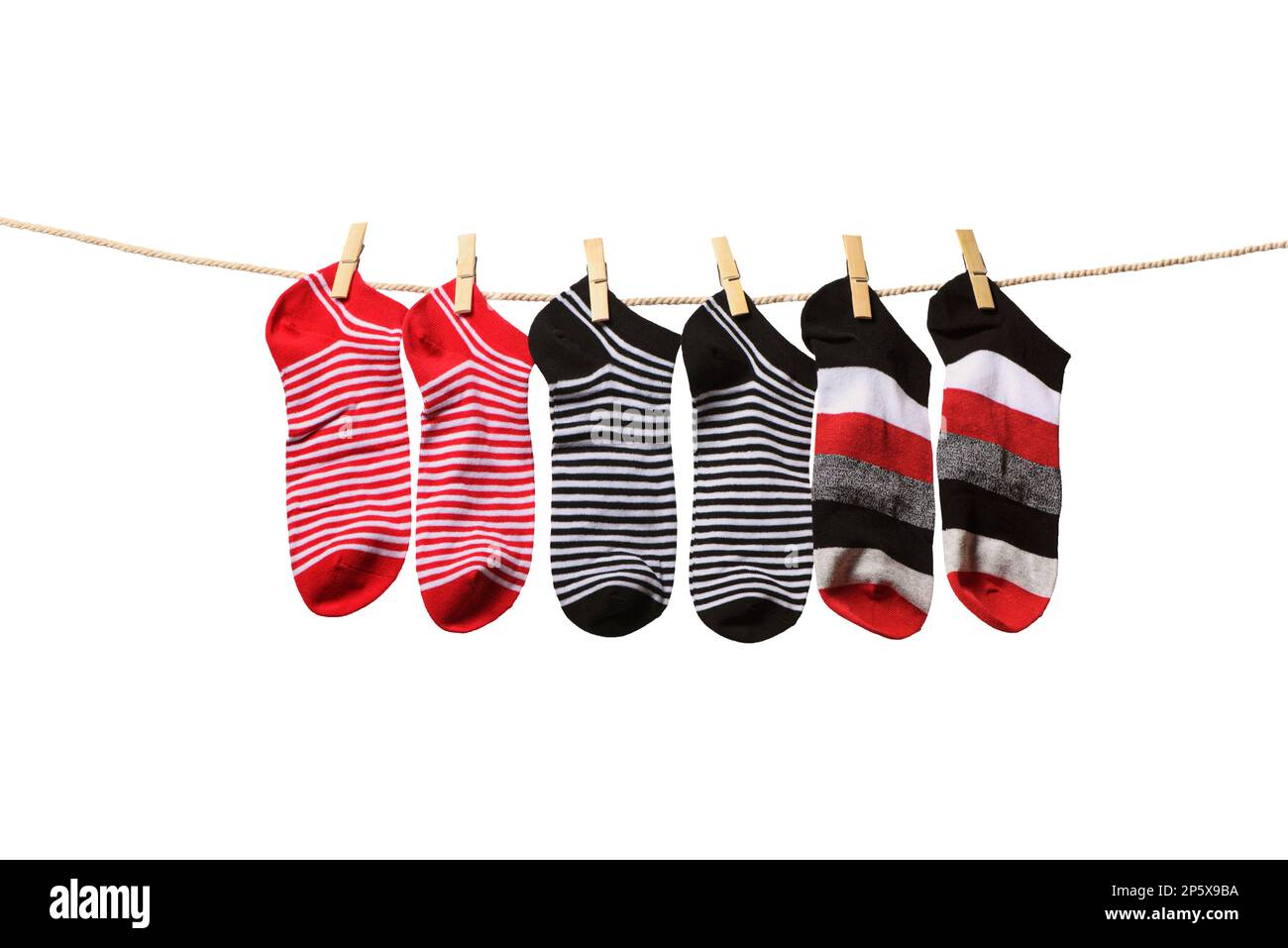 Clean washed striped socks hanging on rope isolated on white background