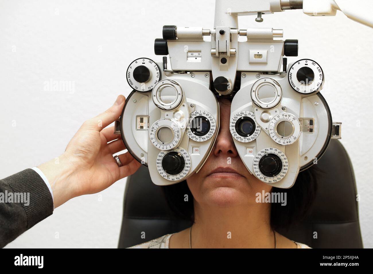 woman at the optician with phoropter Stock Photo