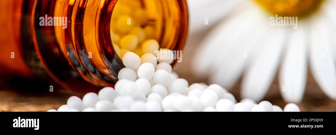 alternative medicine and care with herbal pills and acupuncture Stock Photo