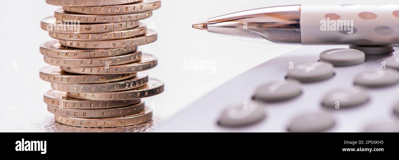 finance, business and economy with calculator and Euro coins Stock Photo