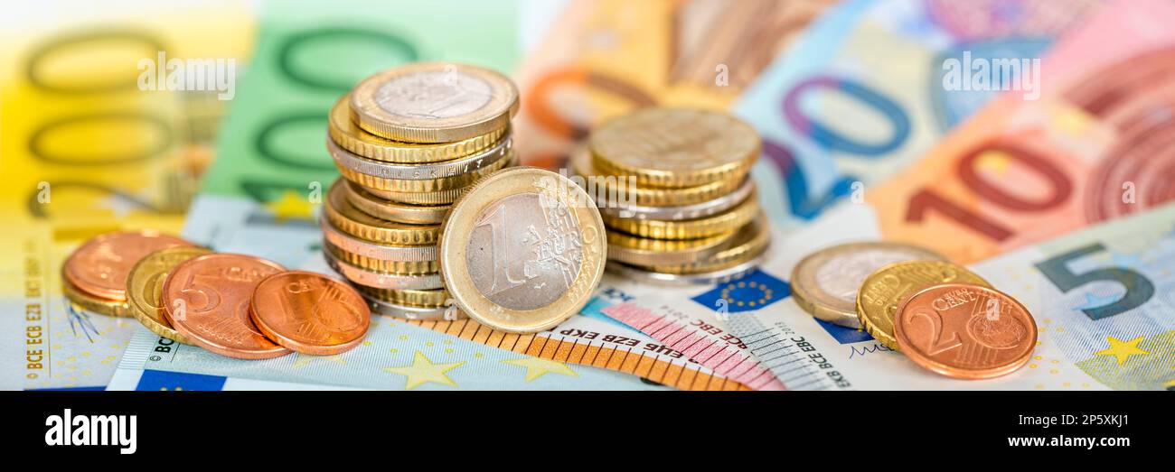 finance, business and economy with calculator and Euro coins Stock Photo