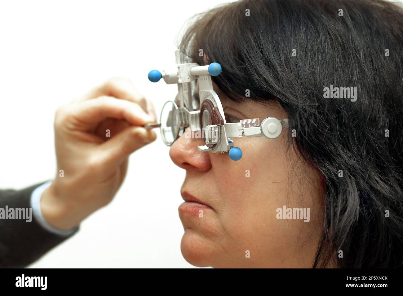 woman at the optician with Ophthalmic trial frame Stock Photo