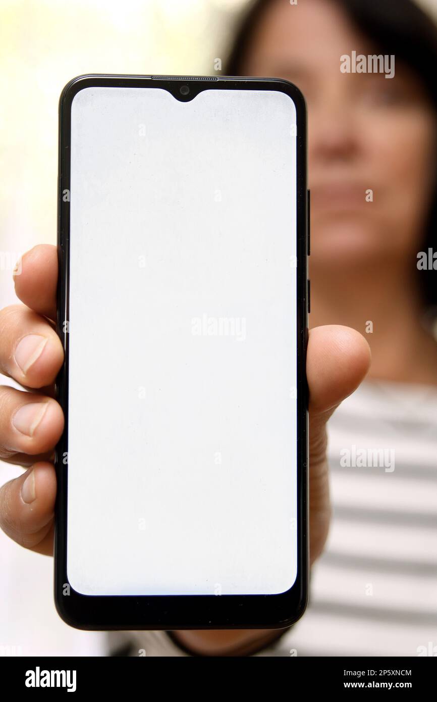 Woman showing smartphone blank hi-res stock photography and images - Alamy
