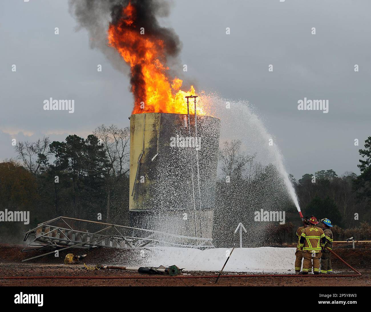 Firefighters from three volunteer departments use suppressant foam to  extinguish a fire in a salt water storage tank at a natural gas well near  Nacogdoches, Texas, on Tuesday, Dec. 4, 2012. Katie