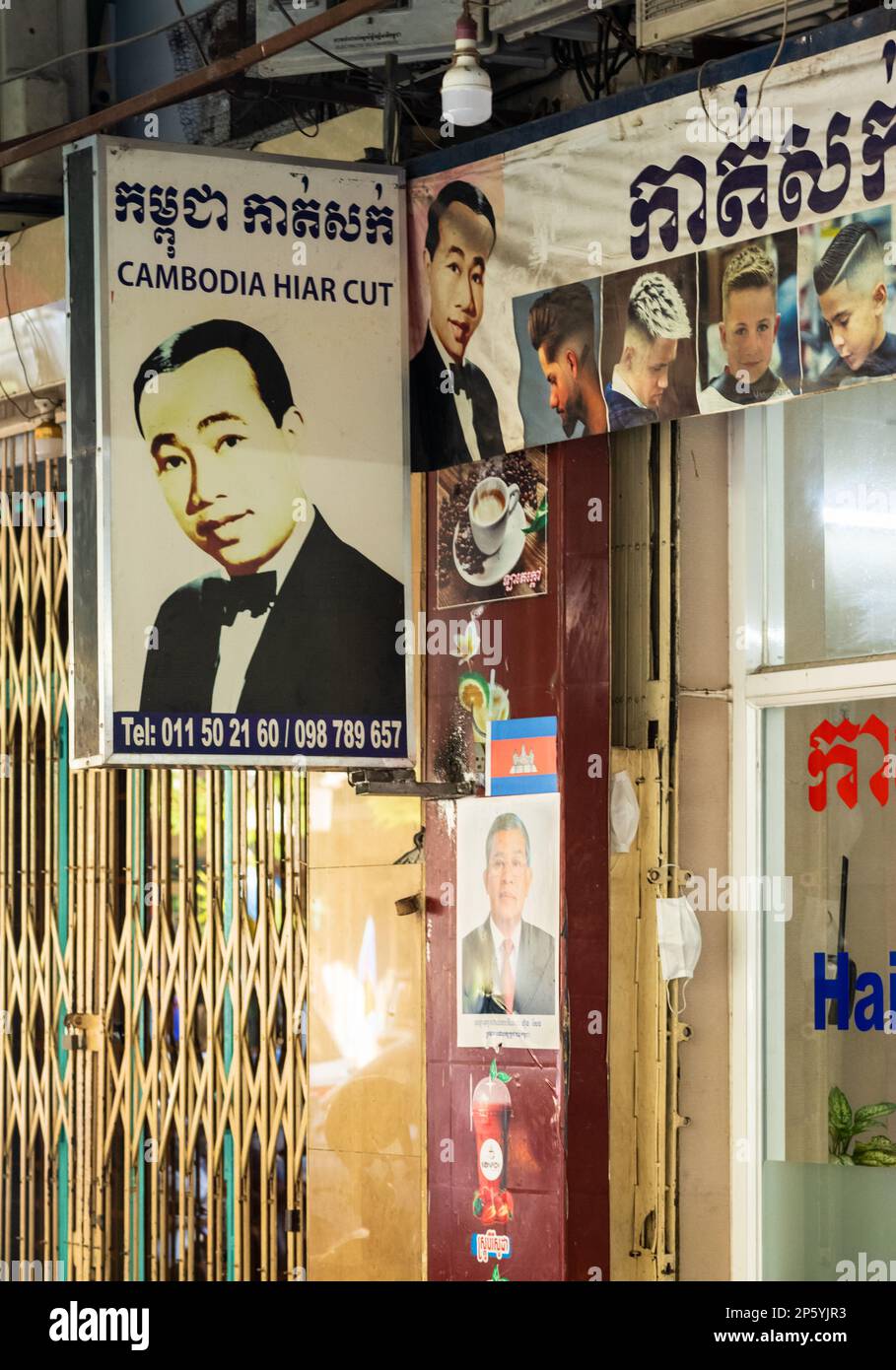 A sign advertising a 'Cambodia Hiar [sic] Cut' outside a barbershop in Phnom Penh in Cambodia. Stock Photo