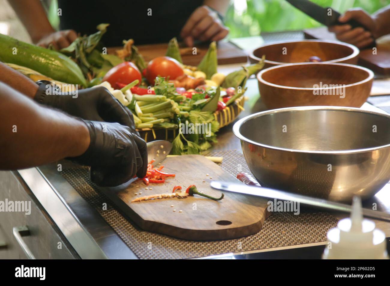 Adult students learning recipe and preparing meal in cooking class