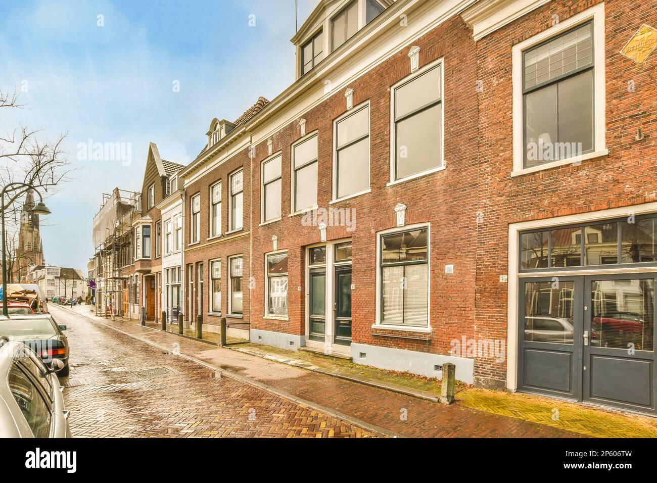a city street with cars parked on the side and buildings in the middle ...