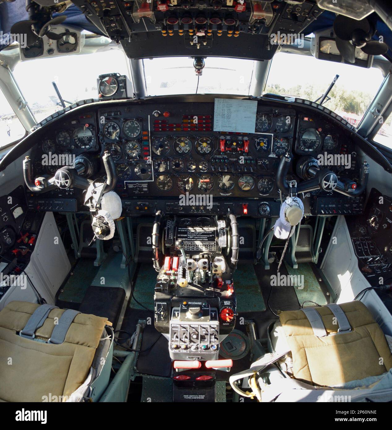 Dashboard, pilot seats, steering wheels in the cockpit of An30, aerial