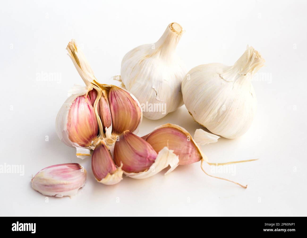 garlic heads and cloves on white background Stock Photo - Alamy