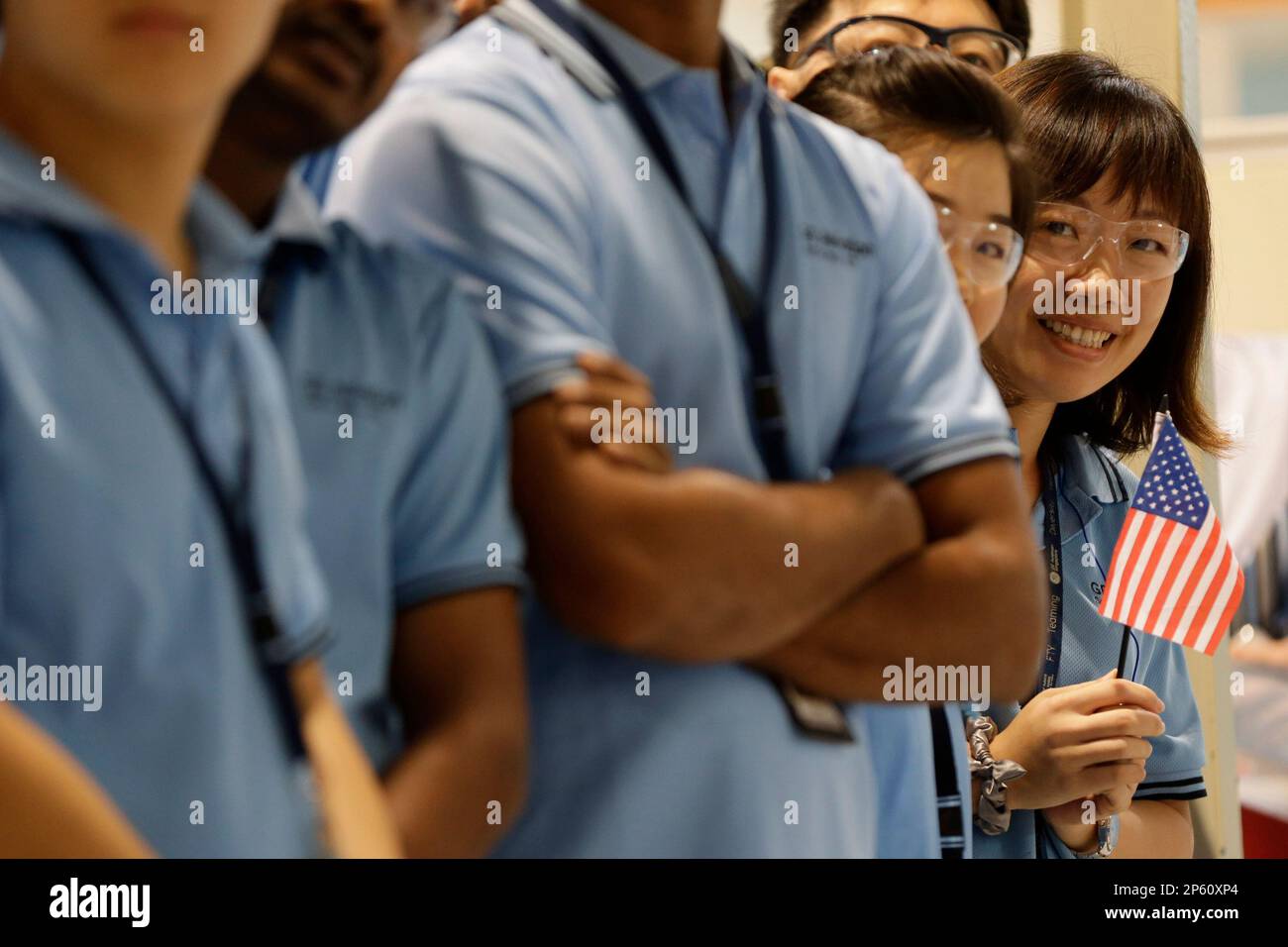 Workers view U.S. Secretary of State Hillary Rodham Clinton, not ...