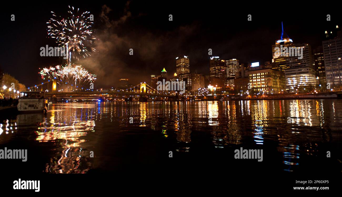 Fireworks reflect in the Monongahela River during Light Up Night in